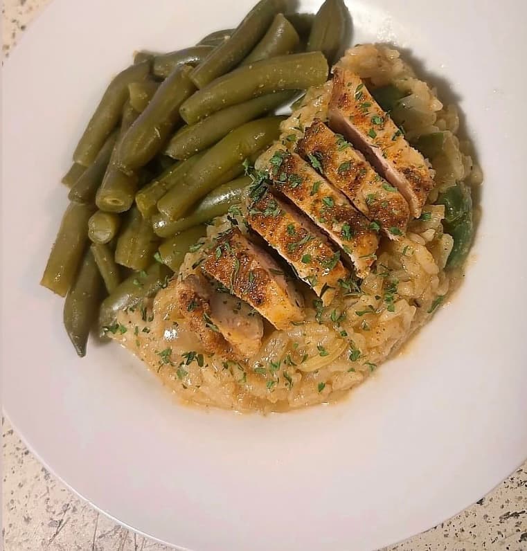 Plated chicken with seasoned rice—hearty catering entrée for corporate and private events